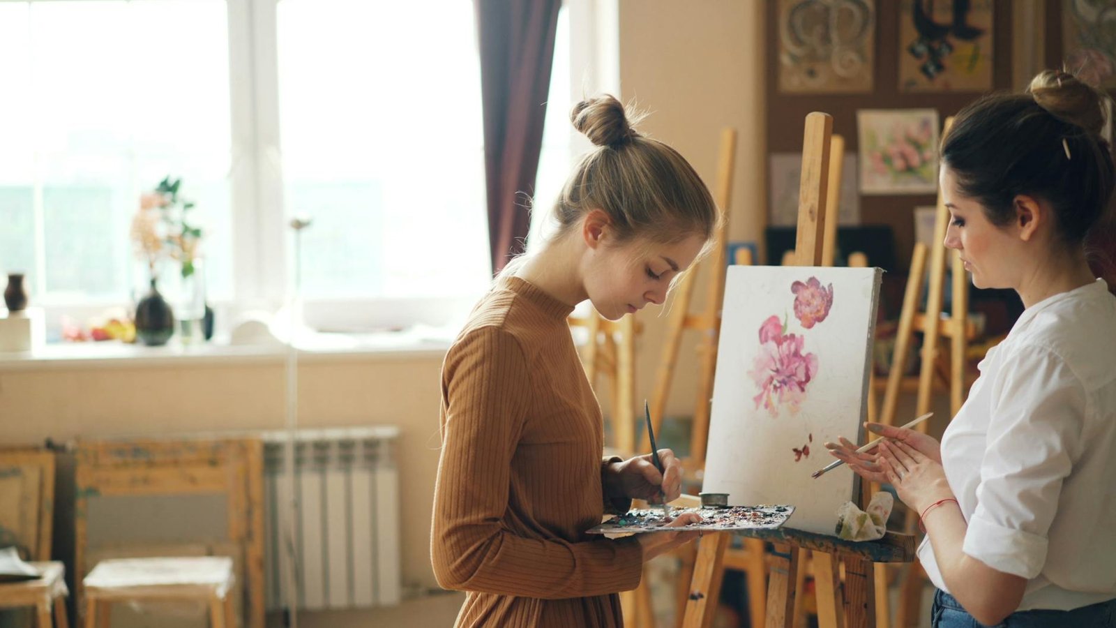 Young women painting together in an art studio
